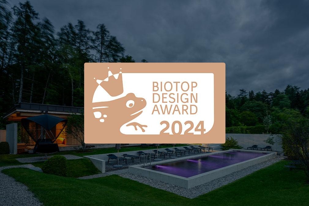 Biopool bei Hotelanlage am Abend mit Beleuchtung und Waldkulisse